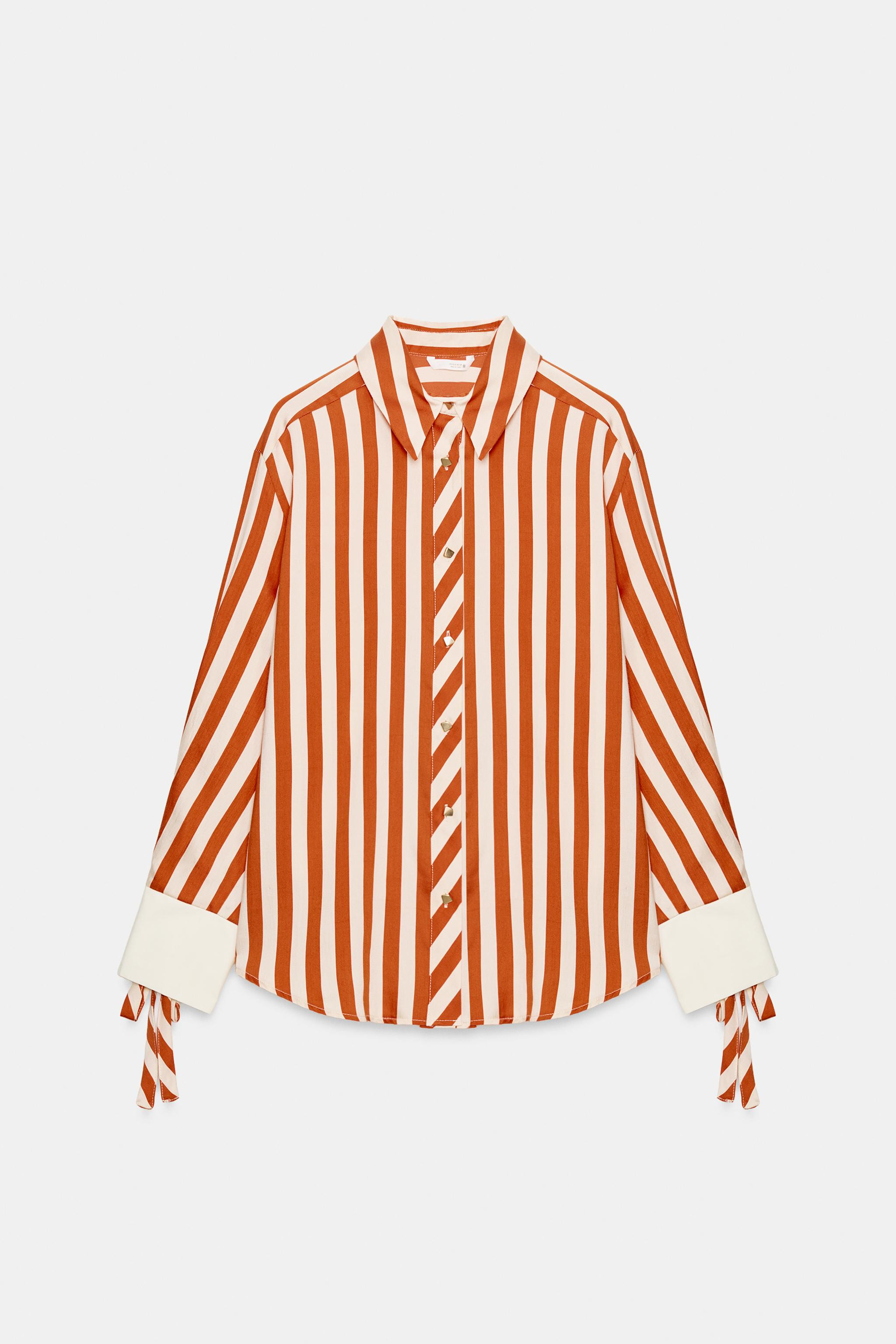 Lapel collar long sleeve shirt with adjustable cuffs featuring a gold eyelet and bow. Front closu... | Zara US