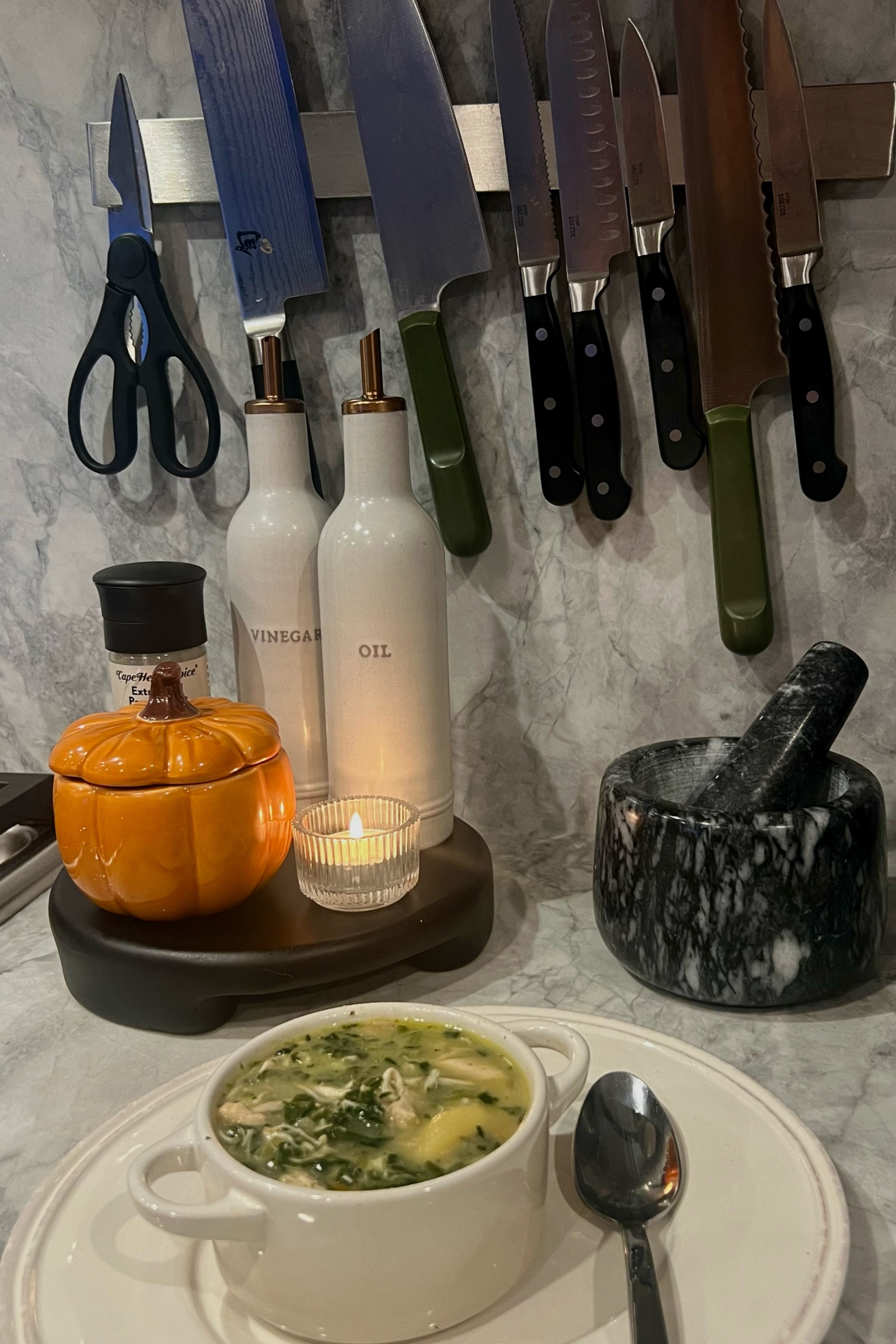 Cozy corner in my kitchen ❤️ obsessed with the look of positioning cute and functional items on a stove-side trivet! Knives and trivet linked 🙂‍↔️

#LTKFindsUnder100 #LTKHome #LTKSeasonal