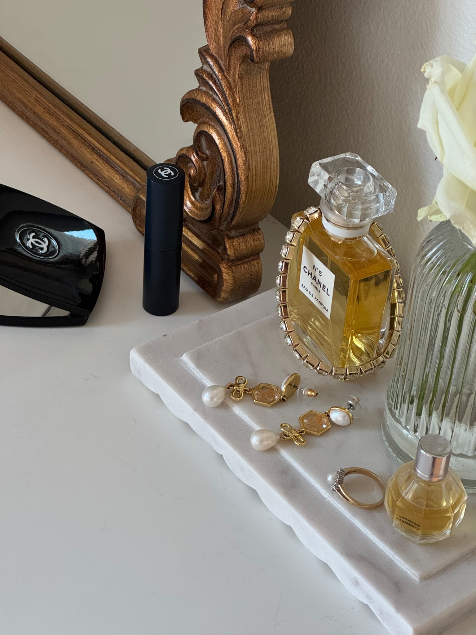 Pretty vanity or bathroom counter details. Chanel lip balm, Chanel mirror compact, Chanel no 5 perfume, pearl jewelry, marble tray 

#LTKBeauty #LTKFindsUnder100 #LTKHome