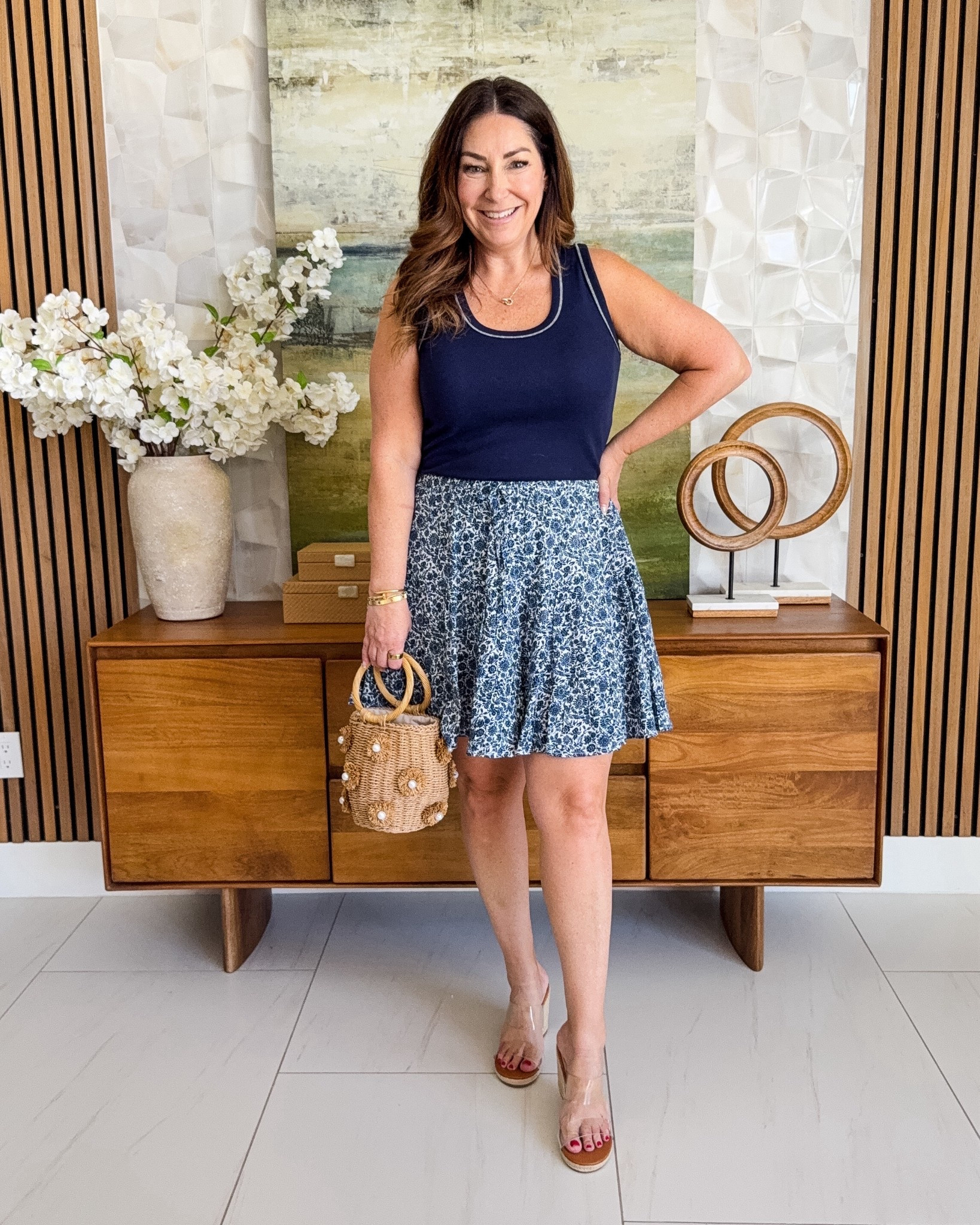 Casual but make it cute 💙 This navy tank and flowy printed skort combo is such an easy warm-weather outfit. Lightweight, breathable, and perfect for anything from errands to casual dinners. Added a fun textured bag for a little extra personality!

Sizing: tank tts, L // skort, L 

#LTKOver40 #LTKMidsize #LTKSeasonal