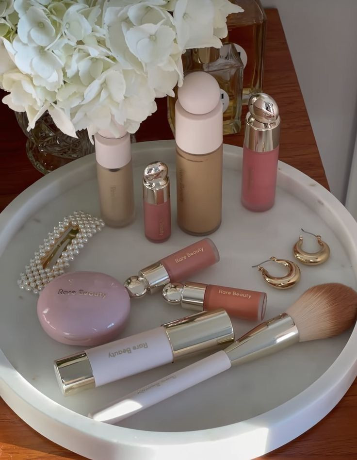 Fresh skin, fluffy blush, and that lit-from-within glow. This is your sign to refresh your makeup routine with light spring glam. 

🌸☁️ Rare Beauty is that girl when it comes to effortless beauty, and I’m living for these soft pinks, dewy bases, and petal-perfect lips 💋

What’s on my tray:
• Rare Beauty Liquid Touch Foundation – breathable + radiant
• Soft Pinch Liquid Blush – gives that “just bloomed” flush
• Stay Vulnerable Glossy Lip Balm – juicy, hydrating & kissable
• The prettiest essentials to keep your glow natural but elevated 

 #LTKFestival #LTKSaleAlert #LTKBeauty