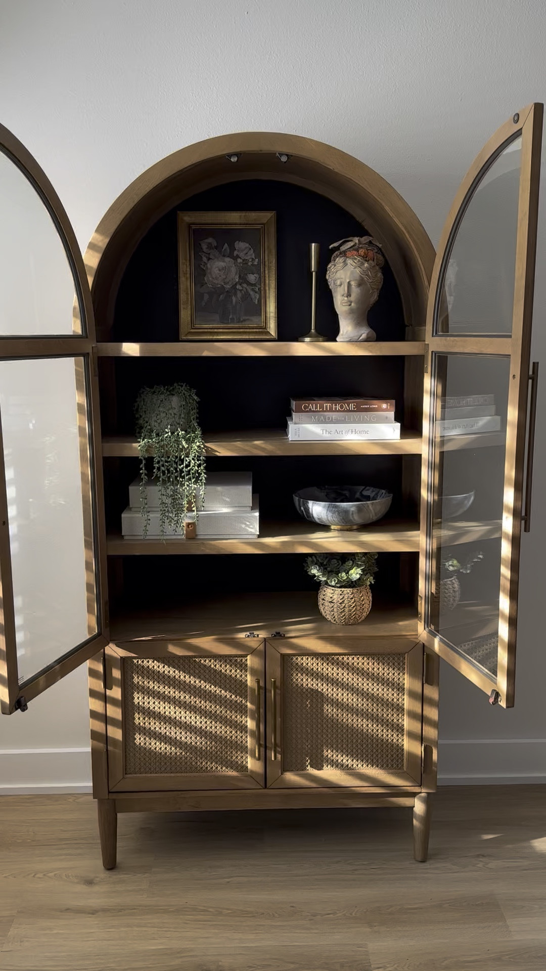 Sam’s Club viral Member's Mark Enzo Storage Cabinet With Rattan Cabinet Doors. Such good quality and finally almost finished styling it!! 

Target vintage floral framed wall canvas Threshhold 

Made for Living: Collected Interiors for All Sorts of Styles book 

The Art of Home: A Designer Guide to Creating an Elevated Yet Approachable Home book 

Decorative Photo Storage Boxes with Lids - Set of 2 Linen Organizers

The marble bowl and plants are TJ Maxx 

Arch cabinet, wood cabinet, shelf styling, shelf decor

#LTKHome #LTKStyleTip #LTKWatchNow