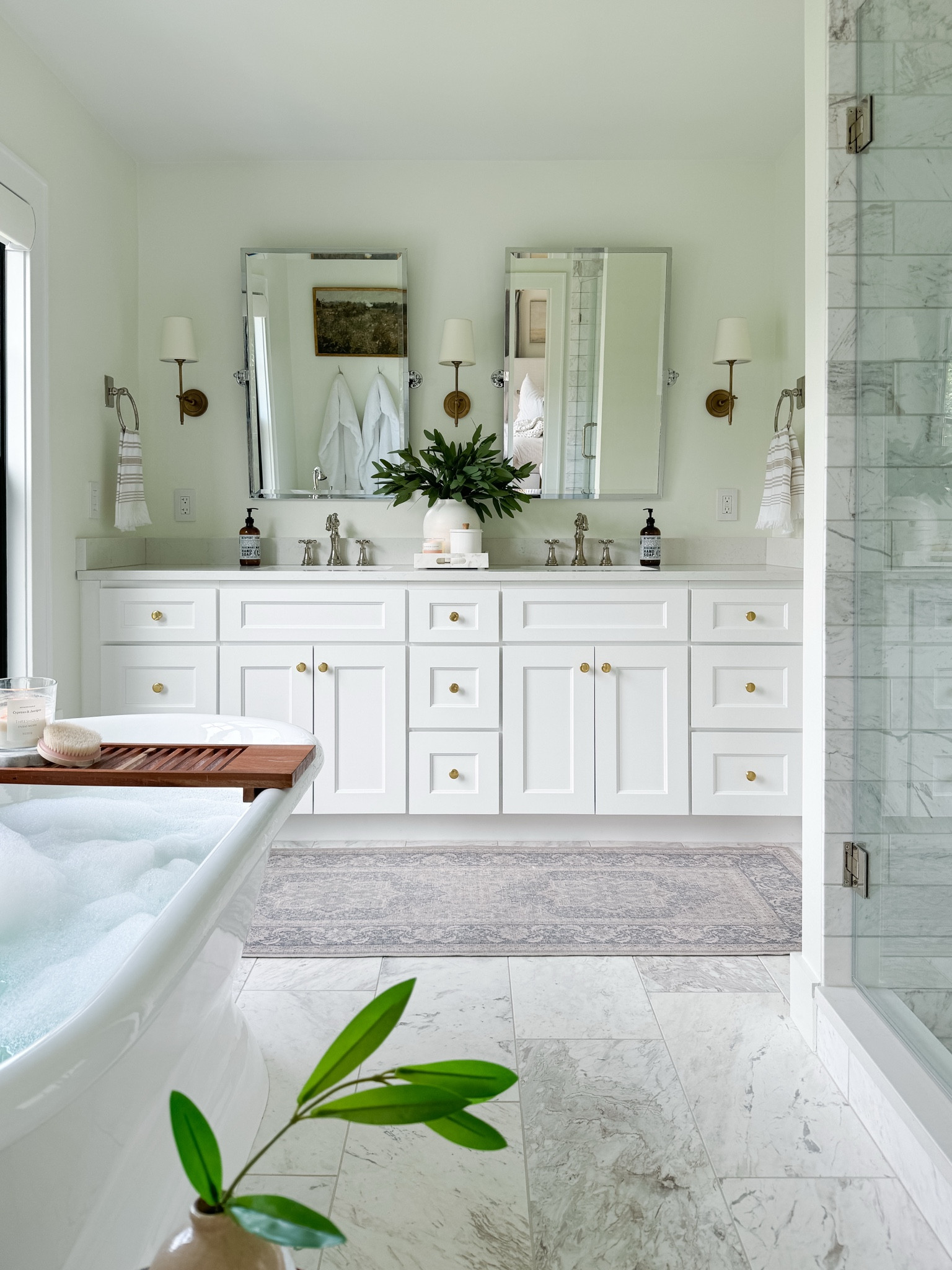Shop my spa like white brass and marble bathroom. I am linking similar marble from Wayfair. My floor tile is 12 x 24, my shower floor is marble hexagon, and my shower walls are 4 x 12 marble. My vanity was custom, but I am linking similar one. I used to mix metals in the space with polished nickel plumbing and brass sconces and knobs. My vintage style runner is washable and I’ve had it for almost 5 years now.

#LTKStyleTip #LTKHome #LTKWatchNow
