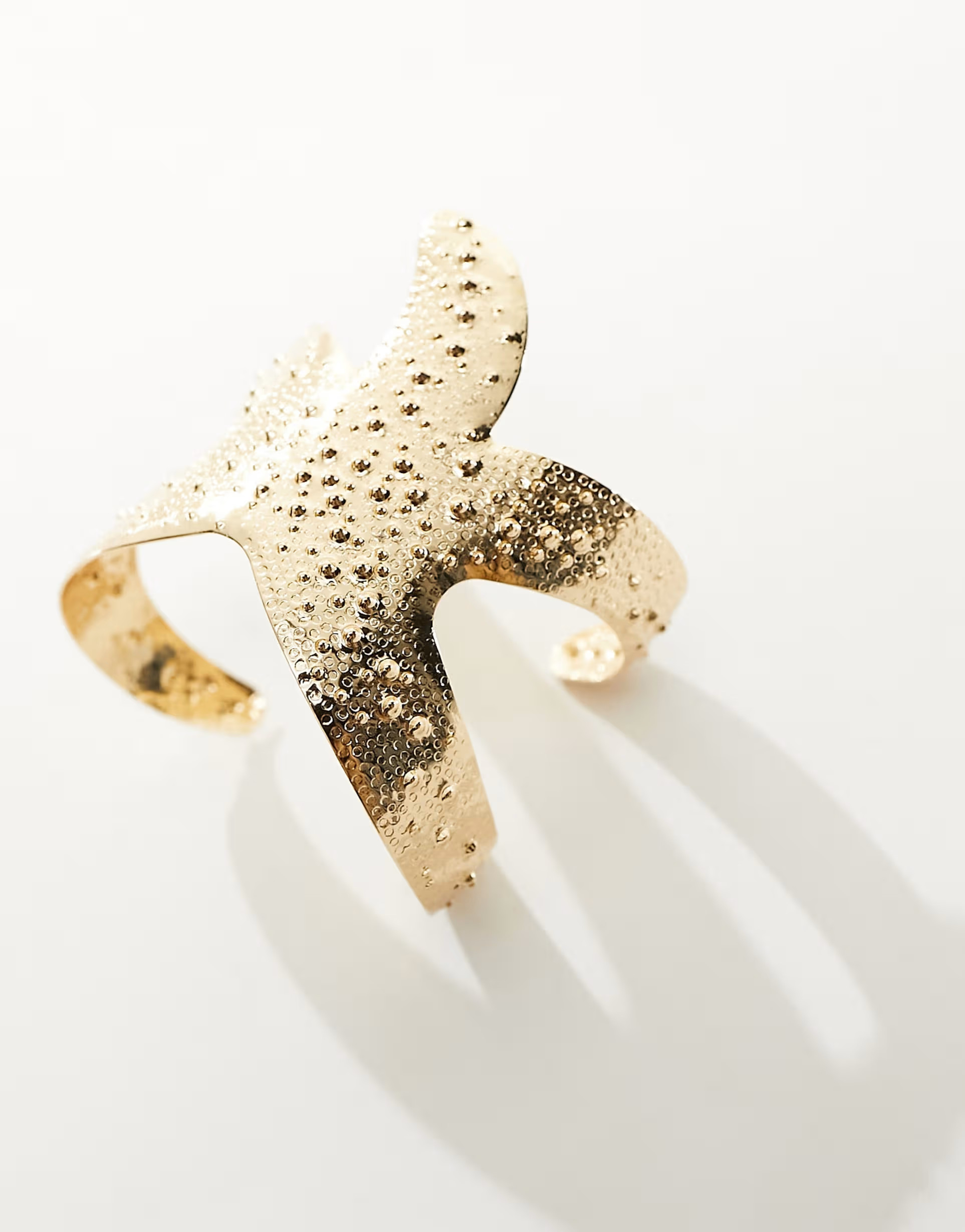 ASOS DESIGN cuff bracelet with textured starfish design in gold tone | ASOS (Global)