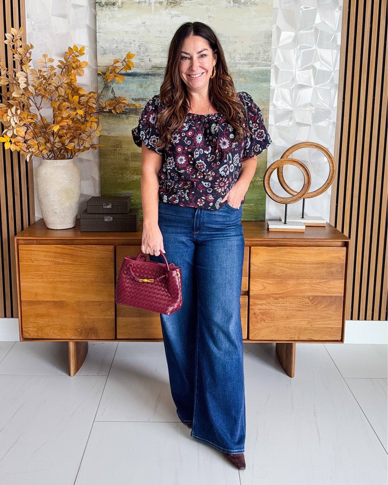 This is such a good jeans-and-a-pretty-top outfit for fall 🍷🍂 Love the floral blouse with wide-leg denim and that pop of burgundy from the bag. Easy, flattering and pulled together without trying too hard! Wearing top tts, L | Jeans tts, 31 

 #LTKSeasonal #LTKOver40 #LTKMidsize