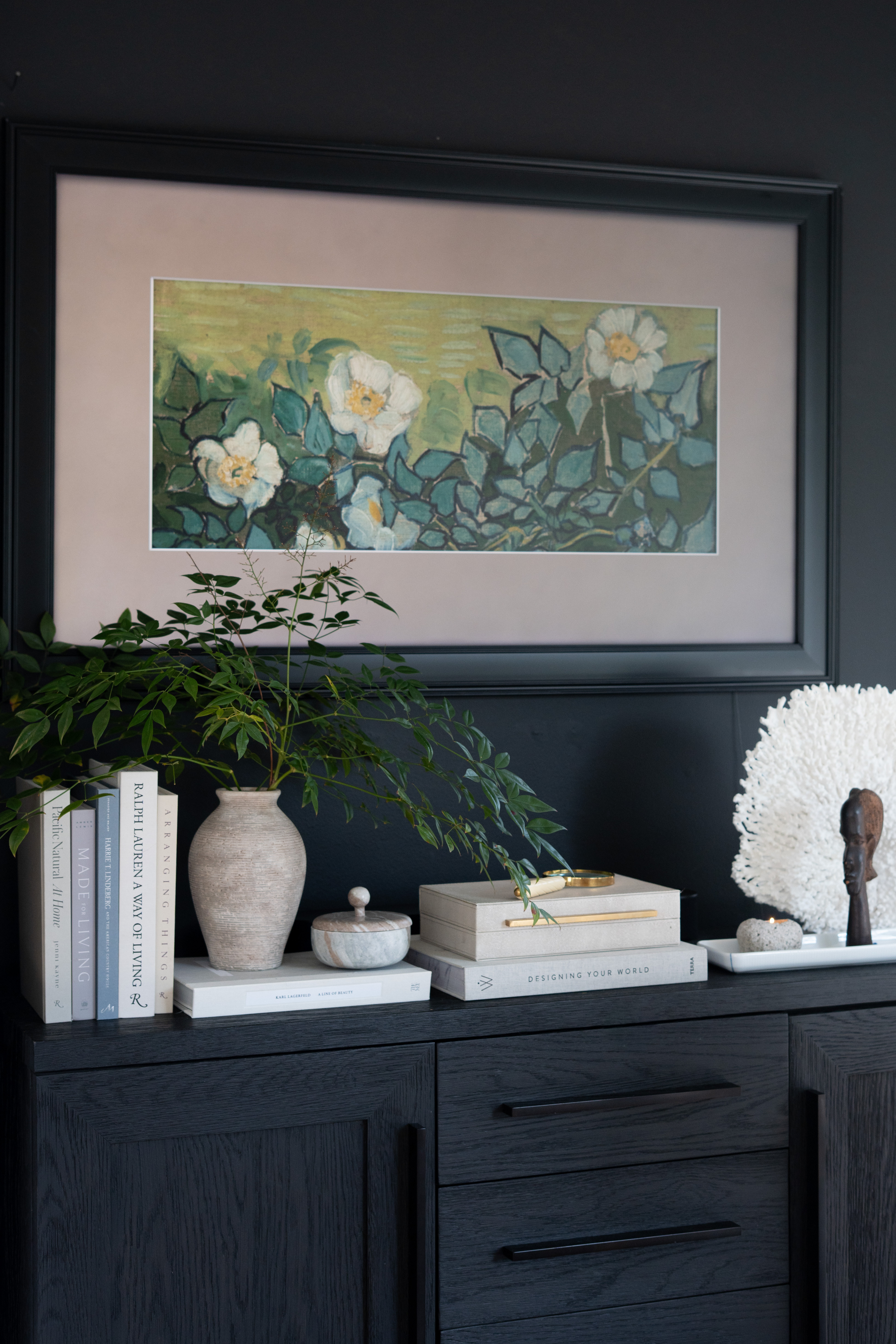 This console moment came together so beautifully. Layered books, sculptural pieces, greenery, and natural textures create such a calm and collected look against the dark cabinetry. I love how the Frame TV above it blends in like part of the artwork.  

 #LTKSpringSale #LTKSeasonal #LTKHome