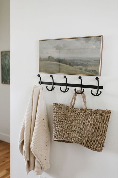 In our entryway we have a coat hook rack with artwork above it. A great spot to hang handbags and coats  

#LTKFind #LTKunder100 #LTKhome