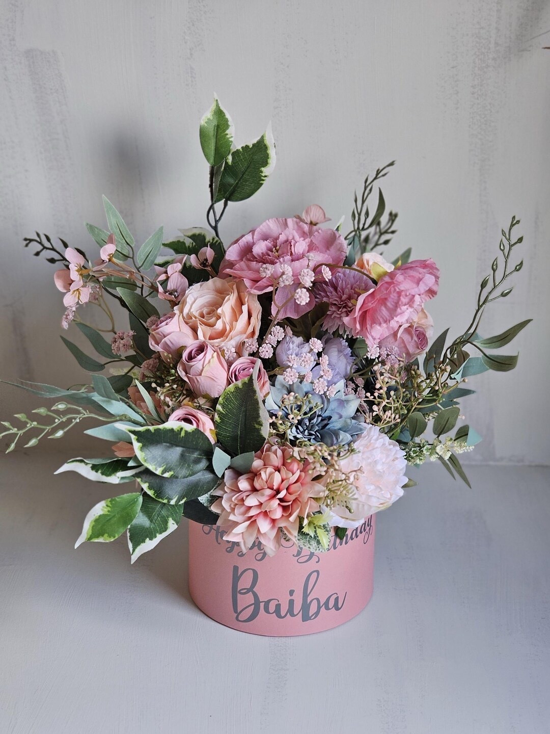 Looking for a gift that feels truly special? This luxury floral hat box arrangement by BlossomBeGifts is handcrafted with premium silk flowers including roses, peonies, dahlias, cherry blossom, and lush greenery. Designed in soft and rich shades of pink, blue, purple, and green, it’s a stunning all-season piece that brings beauty without fading. Perfect for birthdays, anniversaries, thank-you moments, or simply to say “I love you,” this elegant keepsake makes a lasting impression long after the day is over. 💐✨

#LTKgifts #LTKhome #FloralGift #LuxuryFlowers #HatBoxFlowers #GiftIdeas #ArtificialFlowers #HomeDecor #BlossomBeGifts

#LTKFindsUnder100 #LTKHome #LTKSeasonal