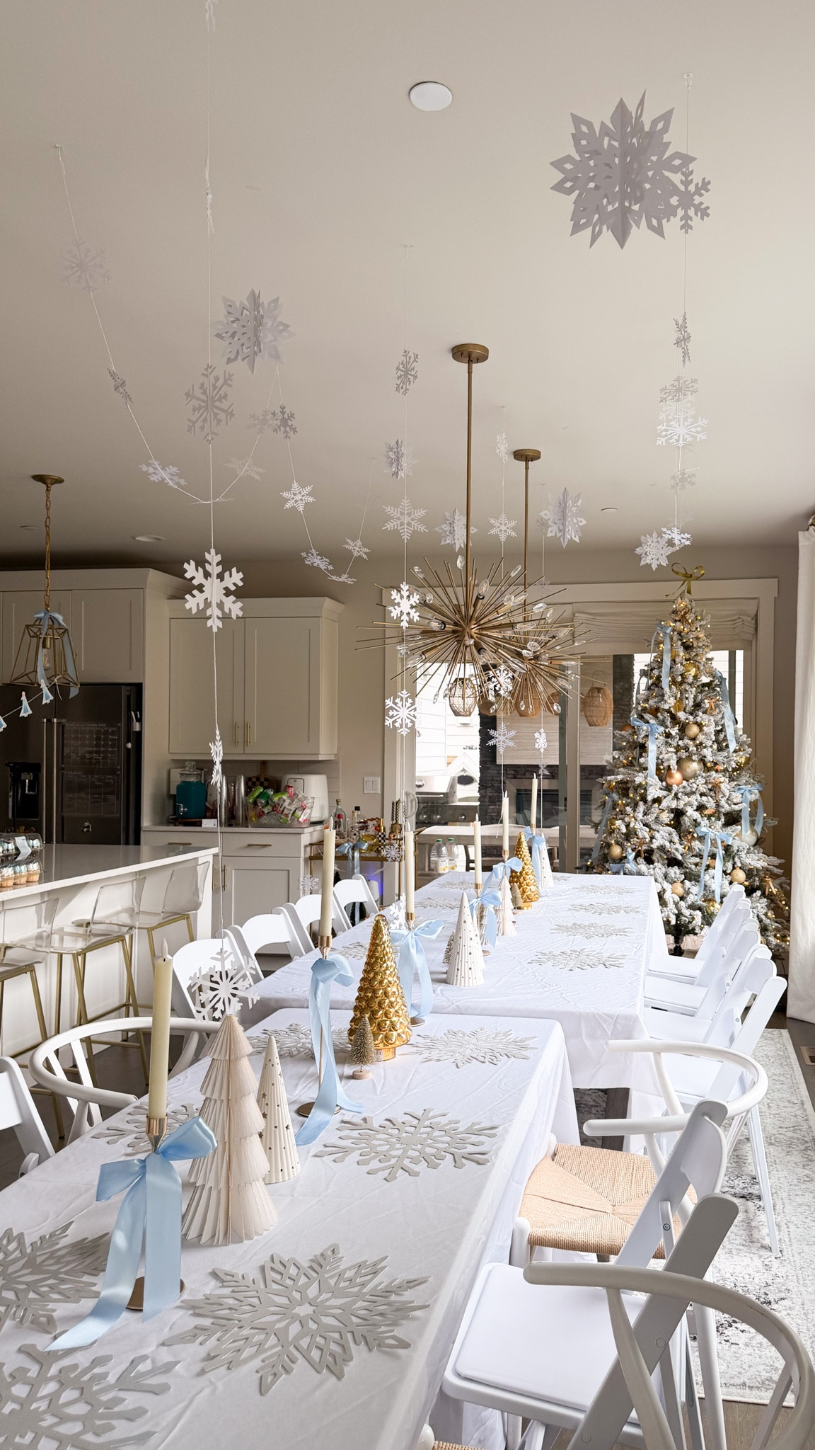 Winter wonderland Frozen theme table setting! 

Tablecloth, chairs, blue ribbon, hanging snowflake decorations, snowflake paper placemats, candle, candle holder, Christmas ornaments 

#LTKHome #LTKHoliday #LTKSeasonal