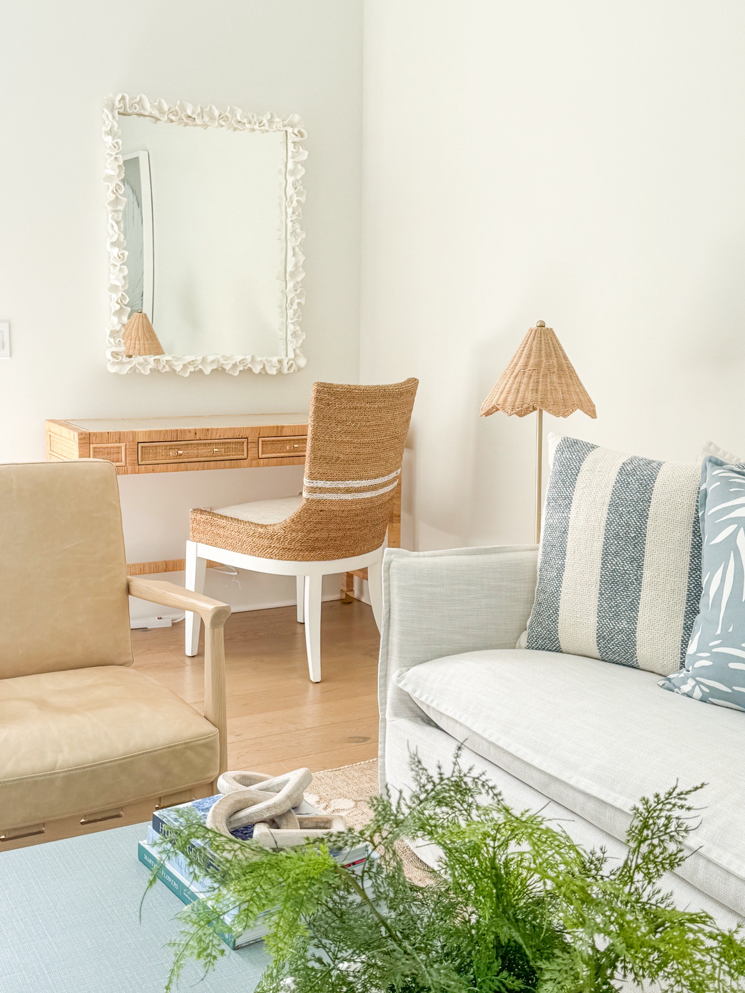 CARRIAGE HOUSE DESK AREA - newly updated with these striped seagrass dining chairs! Our Florida carriage house living room features a slipcovered indoor/outdoor sofa, camel leather chairs, block print rug, a light blue linen coffee table, scalloped rattan lamps, oversized palm art, and light blue tropical pillows! I love our white coral mirror hanging over this affordable rattan desk, too! Take the full tour here: https://lifeonvirginiastreet.com/our-florida-carriage-house-tour/.
.
#ltkhome #ltkseasonal #ltksalealert #ltkfindsunder50 #ltkfindsunder100 #ltkstyletip #ltktravel #ltkover40 coastal living room decor, Serena & Lily style, coastal grandmillennial, coastal grandmother aesthetic 

#LTKSaleAlert #LTKSeasonal #LTKHome