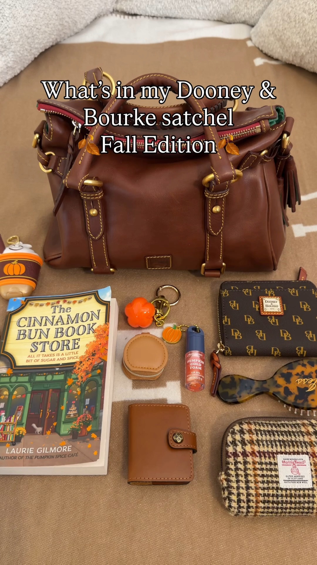What’s in my Florentine satchel fall edition 🍂 Comment SHOP & I’ll dm you the links 🍂

Dooney & Bourke medium Florentine satchel in chestnut 
What’s in my bag:
Cinnamon bun bookstore book
Harris tweed pouch from Amazon
KayAli mini perfume 
Charlotte tilbury pillow talk mascara
Bath and body works pumpkin cold foam lip oil
Dooney and Bourke wallet
Washable reusable gel lint roller ball
Customizable mini hairbrush from Etsy
Initial French hairpin 
Mini jewelry pouch
Bath and body works pumpkin pecan waffle hand sanitizer (my fave scent ever)!
Bath and body works pumpkin spice latter sanitizer holder bag charm
Coach bag chain
Pumping bag charm
Patricia Nash 
Mini notebook bag charm