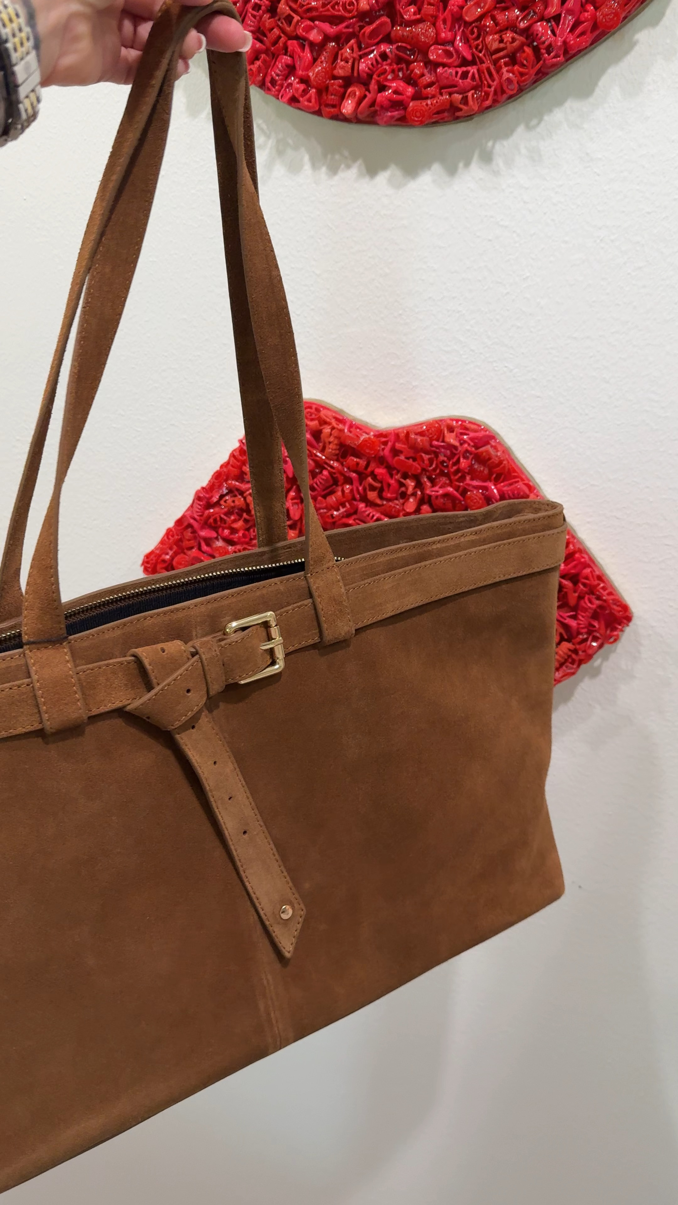 Had to show you this one in motion because the suede texture and the buckle detail don't fully come through in a photo. 
This is Apatchy London's cognac suede tote — structured, zip closure, gold buckle belt detail at the front that makes it look like a decision rather than just a bag you grabbed. The shape holds on your arm without slouching, which matters more than people talk about. A bag that holds its structure reads more expensive than one that doesn't, regardless of price point.
$326 for a suede tote at this quality level is genuinely reasonable. It's the everyday bag that works from a client meeting to a weekend without you having to think about whether it fits the occasion. Cognac suede goes with everything — cream, white, tan, olive, black. The whole wardrobe. 
Treat it with suede protector before first wear. That's the only instruction. 

 