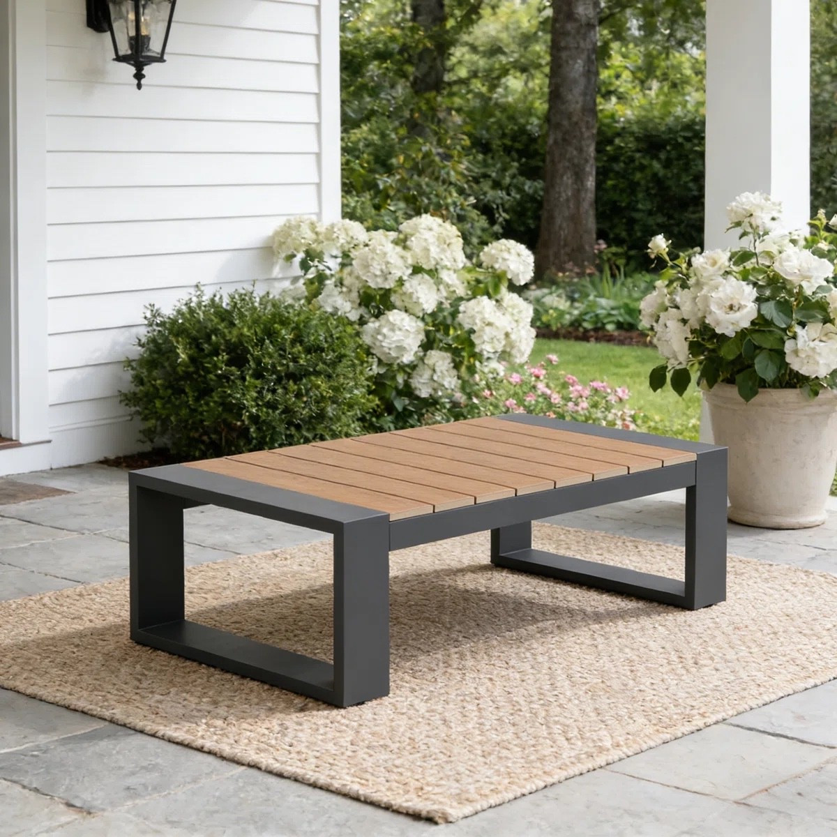 This outdoor aluminum coffee table from Wayfair has such a clean patio look with its warm wood-look slatted top and chunky dark frame. I love it styled over a natural woven outdoor rug with an oversized white planter nearby. It’s currently shown at $269.99 and marked 49% off. Perfect for a porch, deck, or backyard seating area.
