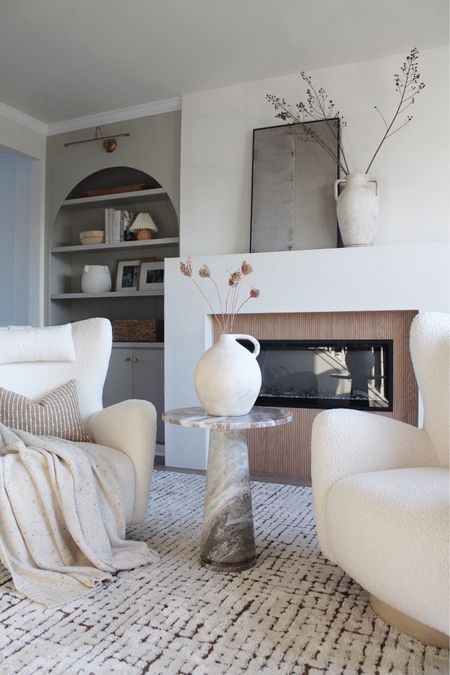Fireplace, marble table, chairs, rug, pillows, vase, lamp 

#LTKstyletip #LTKhome #LTKSeasonal