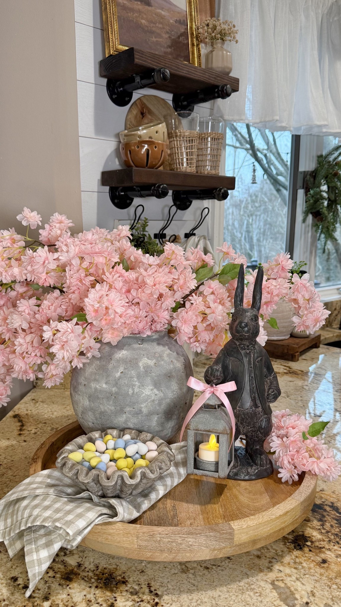 #ad Spring Inspired Centerpiece

Follow @farmtotablecreations on Instagram for more home styling and decor finds. 

There’s just something about a simple spring moment like this that makes a home feel extra warm and inviting. I styled 3 cherry blossom stems in an aged cement vase on a wood lazy Susan, letting those soft blush tones bring life to the space. Paired with the sweetest bunny statue holding his lantern, it creates that cozy, lived-in glow. I finished it off with a bowl of chocolate pastel eggs for a subtle, nostalgic touch of the season. Everything is from @Wayfair and comes together so effortlessly for a look that feels both charming and timeless.

#wayfair #wayfairpartner #springdecor #traydecor #lazysusan #fauxflorals #vases #bunnydecor #kitchendecor #decorativeaccents #springcenterpiece #eastercenterpiece 

#LTKSaleAlert #LTKHome