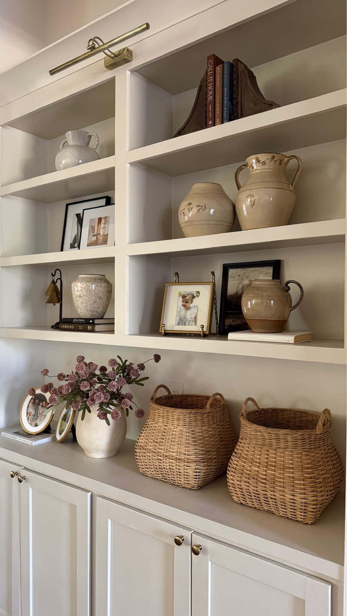 Shelves styled to perfection 🫶🏻 Blending woven details, beautiful ceramics and personal touches created a timeless and welcoming view!

#LTKHome