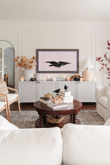 Fall living room decor with faux fall leaves branches, fake crows, spooky decor, classy halloween decor, round wood coffee table, frame tv art, berea chair, ventura chair

#LTKFind #LTKhome #LTKunder100
