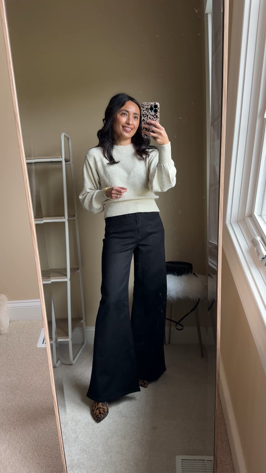 Easy casual chic festive outfit. 
If holiday red isn’t for you, a neutral holiday vibe is just as easy. 
-This embellished sweater has a pretty blousy feel to it. Feels effortlessly fancy with the subtle shimmer from the tiny sequins throughout. True to size for me. On sale for $36. 
-Black jeans that can pass for dress pants if you don’t really want or need dress pants. The high-waisted, wide leg silhouette is a flattering fit and feels elevated. Stretchy denim material.  True to size and in regular length here; could also wear petite length for flat shoes. On sale for $48. 
-Simple gold jewelry for more shimmer. 
-Leopard print shoes for interest. 


#LTKHoliday #LTKFindsUnder50 #LTKOver40