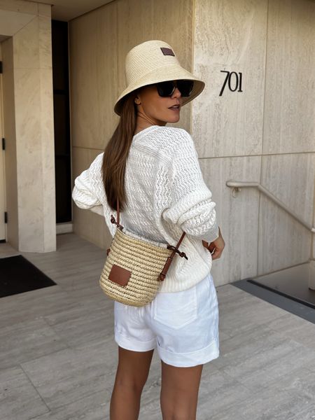 Spring to summer outfit! Summer whites, knit sweater, linen shorts, raffia bag, summer hat, summer bag. 

#LTKItBag #LTKTravel #LTKStyleTip