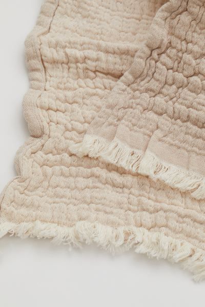 Conscious choice  BabyThrow in soft, woven cotton fabric with fringe at short sides.CompositionCo... | H&M (US + CA)