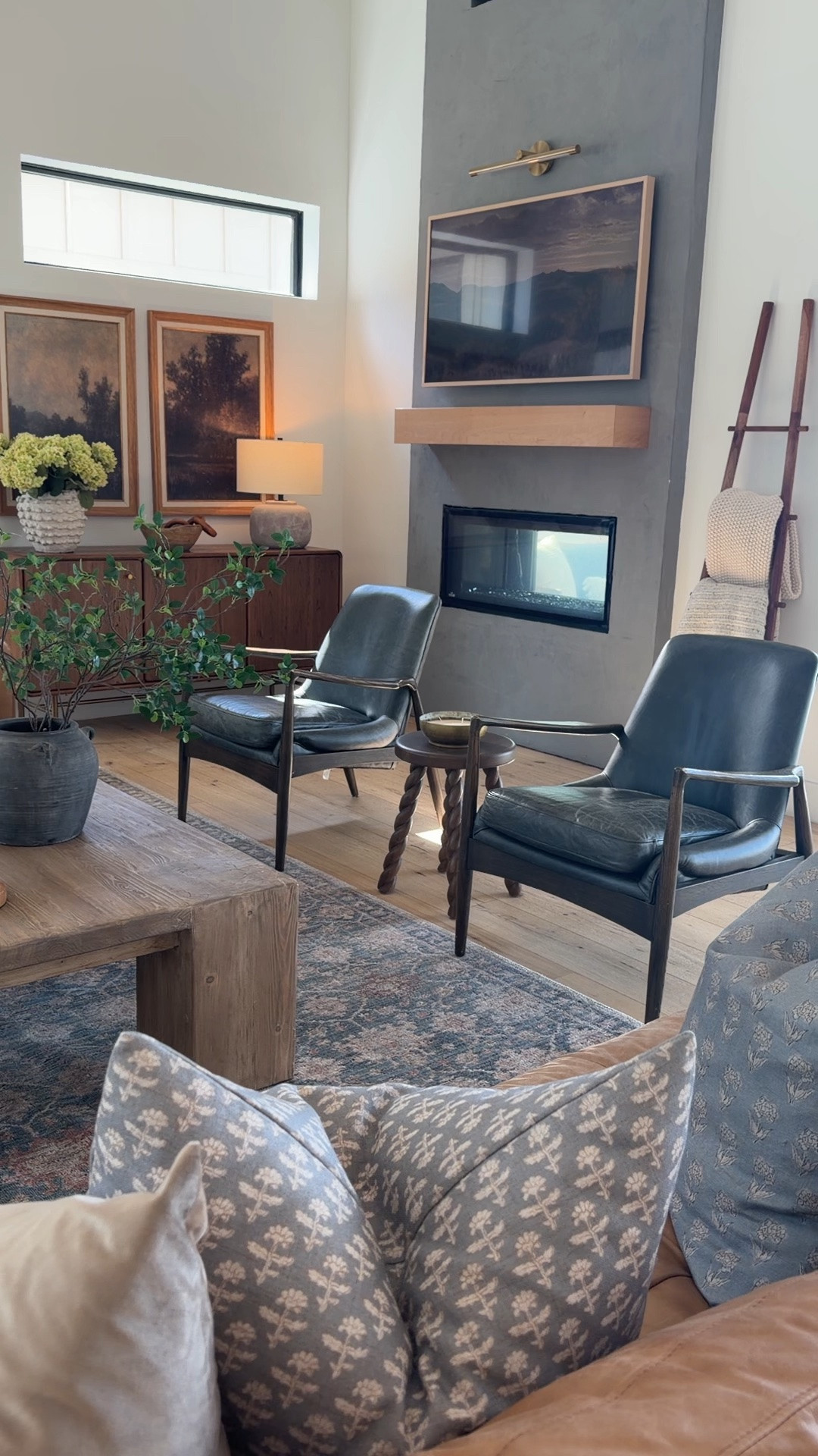 Our living room has slowly turned into my favorite room in the house 🤍 I wanted it to feel warm, collected, cozy, and a little elevated while still being family-friendly, and these pieces completely transformed the space.

The hero pieces are definitely the vintage-inspired area rug, the warm leather sofa, the black leather swivel chairs from Magnolia, and this chunky wood coffee table that grounds the whole room so well. I love mixing organic textures, rich wood tones, soft neutrals, and darker accents to create that cozy modern organic look that still feels timeless.

living room decor, modern organic living room, leather couch, black leather chairs, Magnolia home decor, vintage inspired rug, oversized coffee table, cozy neutral living room, warm modern home, designer inspired living room, layered textures, neutral home decor, organic modern style, earthy living room, swivel chairs, high end home decor, collected home style, cozy family room inspiration

#LTKHome #LTKSeasonal #LTKSaleAlert