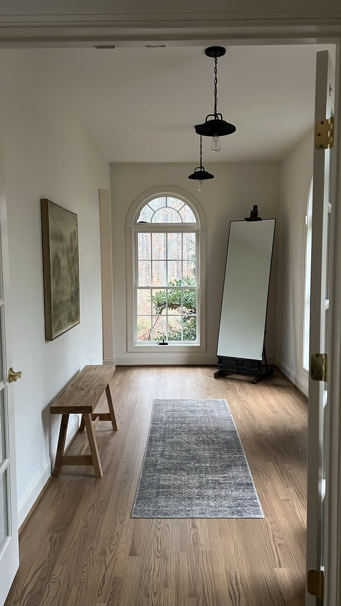 Hallway styling and decor! This vestibule has become one of my favorites. What do you do with. Long hallway? Add pendant lights, a skinny bench, large canvas art and a floor mirror!

Loloi runner, Amber interior vibes,
Oversized art, Large scale art, antique bench

#LTKStyleTip #LTKSaleAlert #LTKHome