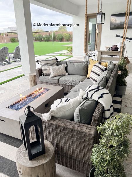 Our outdoor patio furniture set is on sale! Outdoor sectional plus table behind the sofa, two Ottomans on sale. Fire table. Propane tank is hidden under the table behind the couch. Fire pit, black and white striped outdoor rug, outdoor lantern, pottery barn, wayfair, Walmart, Better Homes & Gardens, outdoor furniture, outdoor couch, summer furniture, home decor, modernfarmhouseglam

#LTKhome #LTKSeasonal #LTKsalealert