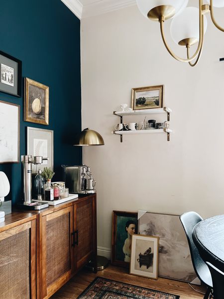 Dining room gallery wall, sideboard and coffee station. 
-
Target Threshold - Nespresso - Aarke - World Market - affordable dining room decor - marble wall shelves - gold brackets - gold dome floor lamp - vintage portrait art - vintage citrus art - Studio McGee framed art - navy blue accent wall - dining room accent wall paint color - Benjamin Moore Gentleman’s Gray paint - vintage rug - dining room decor - glass ball chandelier - West Elm - round black dining table RH - black Eames style dining chairs - affordable dining room furniture - affordable sideboard cabinets - affordable home decor 

#LTKhome #LTKsalealert