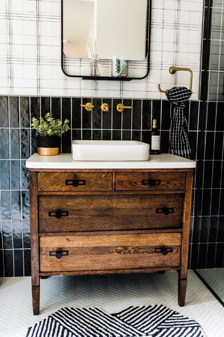 Mixing patterns using the same colors on repeat adds so much texture to this bathroom!

#soldierstacktile #blacktile #plaidwallpaper #herringbonetile #blackandwhite #bathroomdecor #bathroomdesign 

#LTKfamily #LTKhome #LTKstyletip