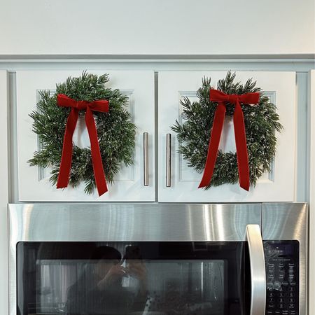First Christmas touch to my home. I was looking for this small wreath to put on the cabinets and I love how they look.  Very simple but classy decor with red velvet ribbon 

#LTKhome #LTKHoliday #LTKGiftGuide