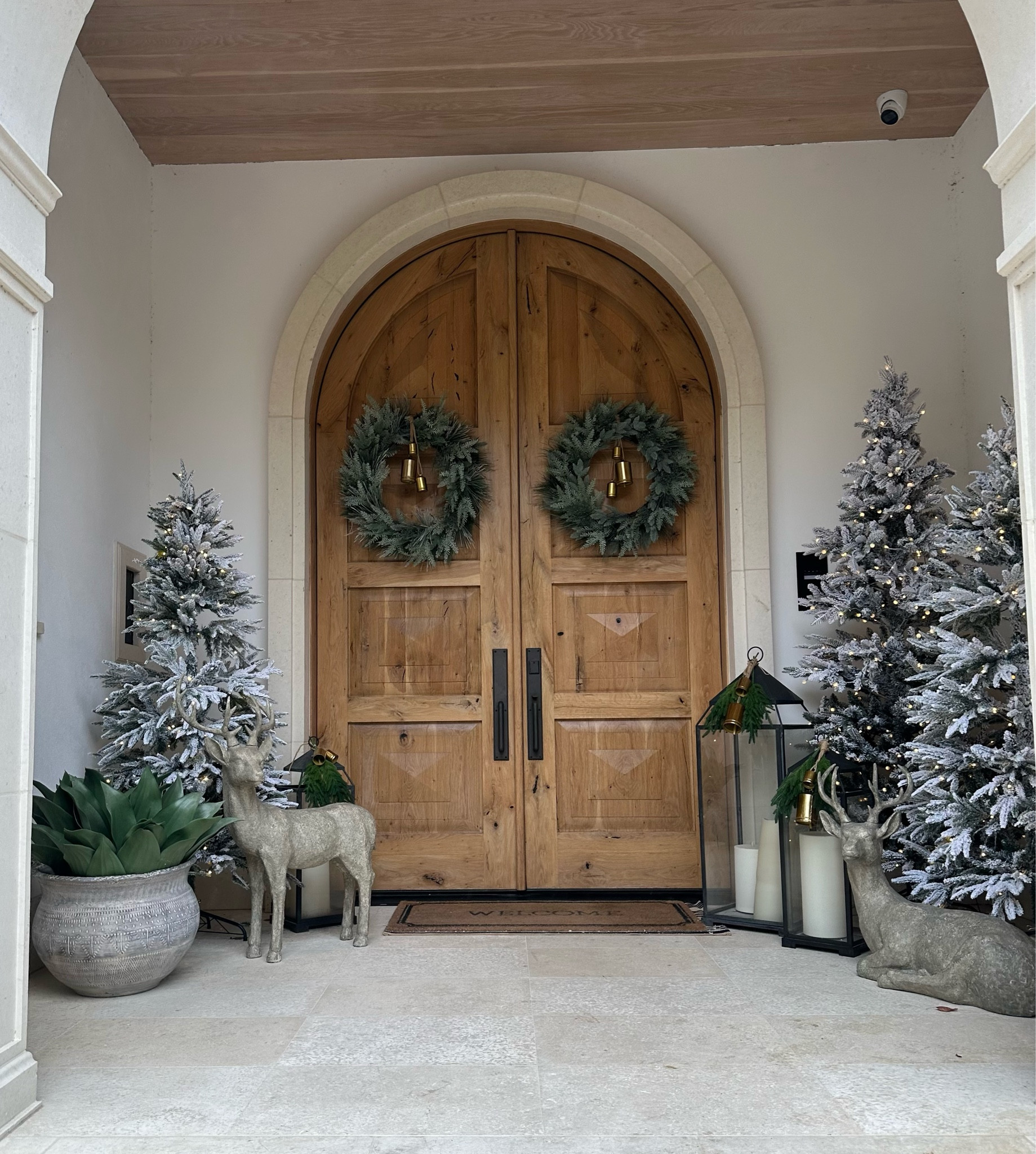 Our holiday porch! 🤍🤍🤍 A winter wonderland with flocked trees, reindeer, wreaths, and lanterns. Simple, Classic, and Cozy 🌟🌟🌟

#LTKHome #LTKHoliday #LTKSaleAlert