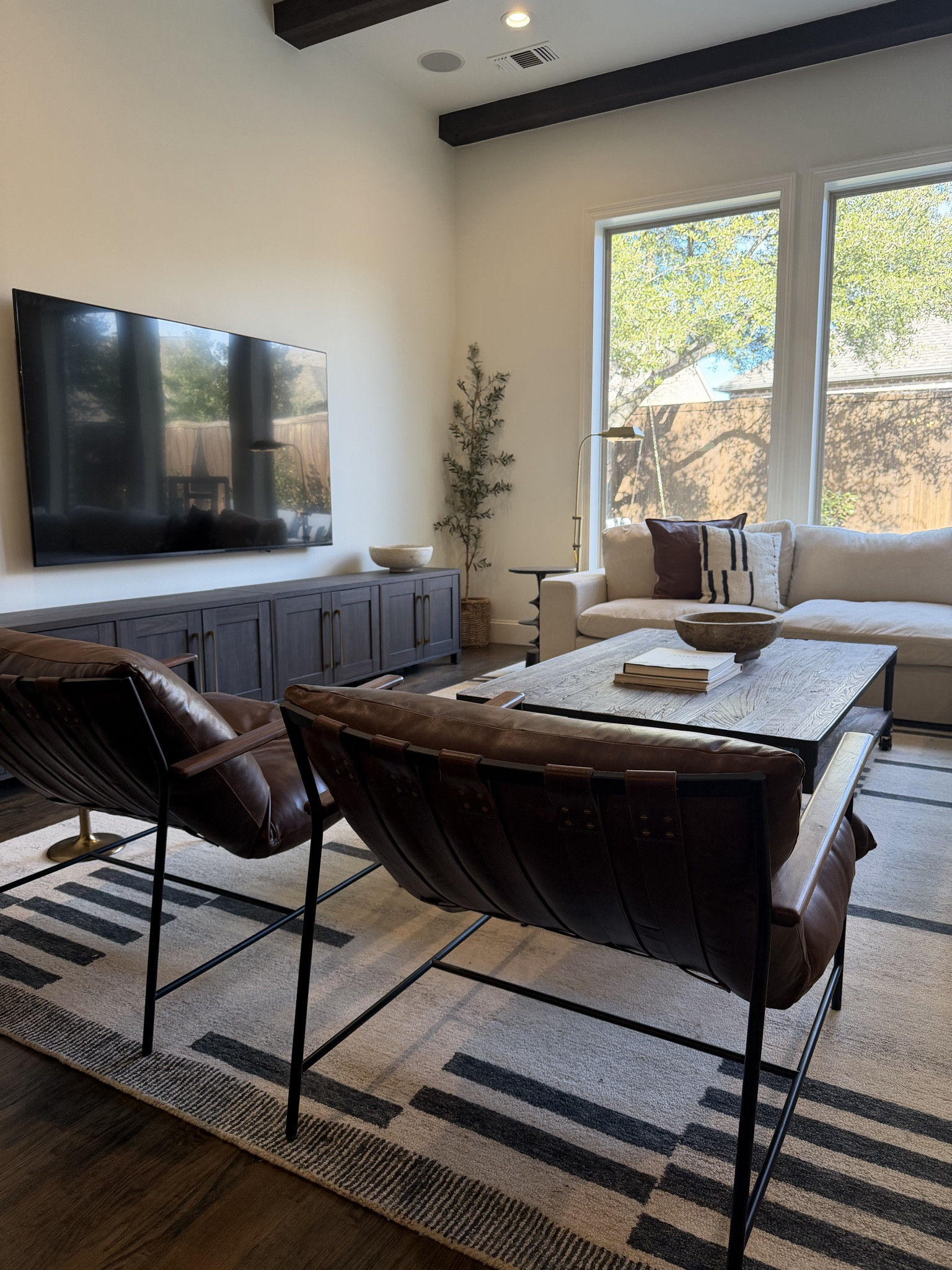 Layered neutrals and warm textures make this living room feel cozy but still pulled together. Mixing leather, wood, and soft textiles is my favorite way to create a space that feels both comfortable and timeless.

#LTKmomlife #LTKSeasonal #LTKHome