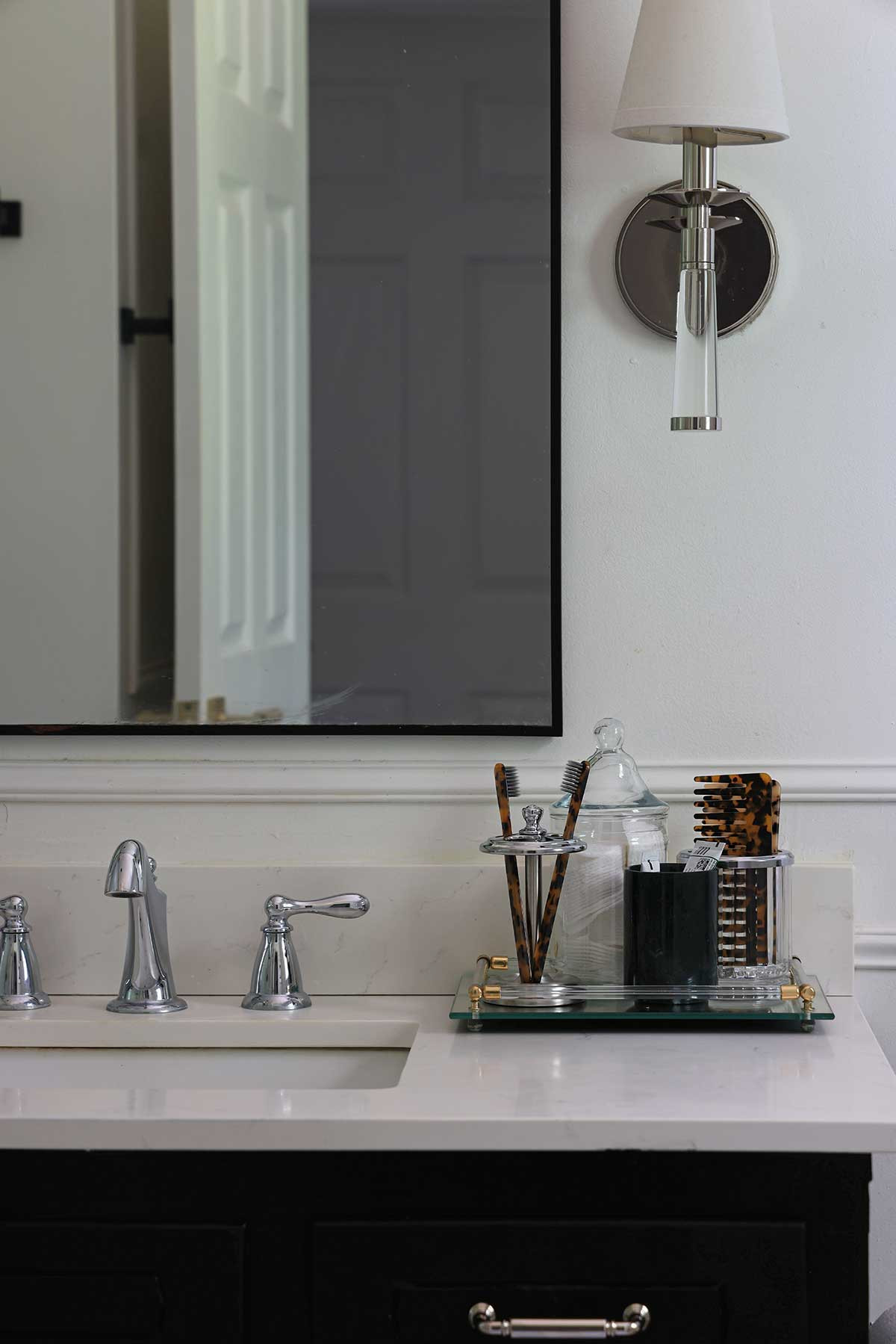 Bathroom styling | Nickel toothbrush holder, marble toothbrush holder, tray, tortoise shell tooth brush and hair comb, nickel drawer pulls, nickel sconces.  

 #LTKHome