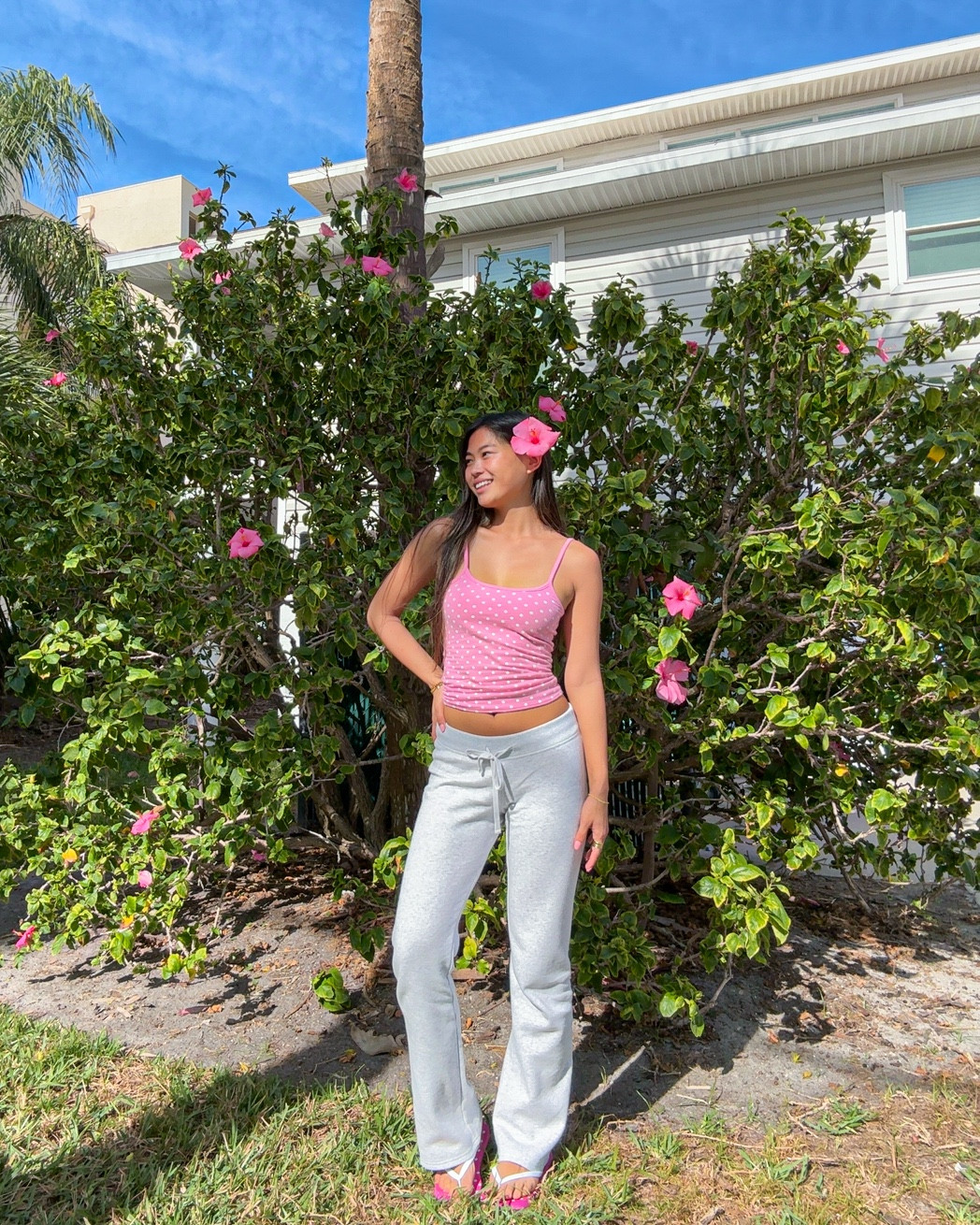 spring break outfit idea | wearing a reversible tank top. it’s pink with white polka dots on one side and fully pink on the other. i’m also wearing low rise sweatpants with a drawstring waistband and California embroidered with patch letters on the back. i’m wearing a size XS top and XS Regular in bottoms.

#LTKdayinmylife #LTKTravel #LTKootd