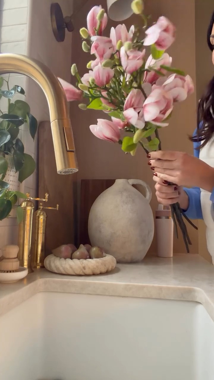 I just unpacked these magnolia stems and had to stop for a second because they look that real. The petals have that soft variation, the branches feel natural, and they don’t have that obvious faux shine. I wanted something that would last but still feel organic in the kitchen, and these instantly delivered. One of those pieces that makes a space feel finished without trying too hard. Linked for ya below . 

#LTKHome #LTKSaleAlert #LTKSeasonal