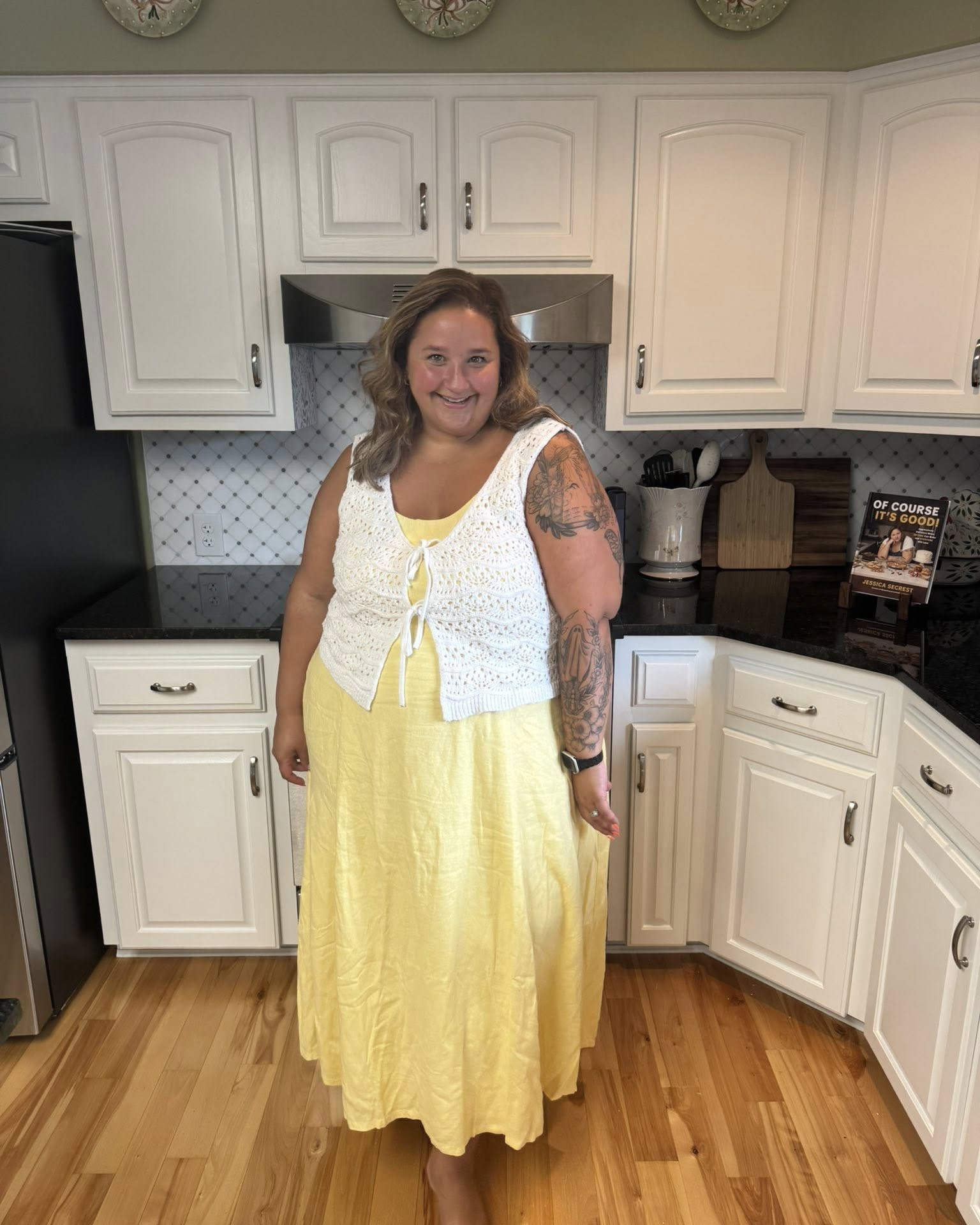 Happiness has no weight limit. 
You deserve to smile. You deserve to take up space. You deserve to wear the cute clothes—yes, even the crop tops, bikinis, and sleeveless dresses—no matter what number is inside your jeans. For me, that number is 24.
Did I spend years wishing I was smaller? Absolutely. I grew up in the early 2000s, where thin wasn’t suggested, it was demanded if you wanted to be seen as valuable. And let me tell you, 2000s skinny was brutal. I couldn’t compete, so half the time I felt invisible. But did that stop me from wearing what I wanted? Nope.
Somehow I built this “I don’t care” armor, even though the world around me very much did care about size. And honestly, to hell with that. I’m worth more than a number in my jeans. I’m happier when I dress for myself, not for society’s approval. I don’t need to hide in baggy clothes or shrink myself into the background.
I’m not grotesque. I’m just a woman in her kitchen, feeling cute in a butter-yellow dress, asking her husband to snap a picture because this moment deserves to be remembered. And so do you. 
Get in the pictures. Your future self will thank you. Because when I’m old and wrinkled like a prune someday(and I fully intend on living that long), I’ll be grateful to see this version of me smiling, dressed how I want, living my life on my terms.
Smiles are One Size Fits All.
Pictures are for everyone.

I love this dress, the sizing is generous and I am wearing a 2x!

#LTKSeasonal #LTKStyleTip #LTKFindsUnder100