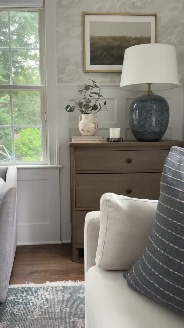 This little corner has so many pieces I love together. The blue statement lamp adds beautiful color, while the warm wood dresser, framed art, and layered textiles keep the room feeling classic and collected.

blue table lamp, statement lighting, wood dresser, living room decor, coastal home decor, neutral interiors, framed wall art, accent pillow, layered home decor, traditional home style, timeless interior design, girlonthehudson

#LTKHome #LTKSeasonal #LTKdayinmylife