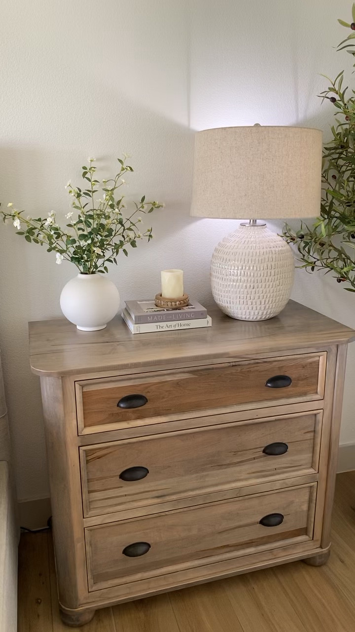Nightstand with vase, flower stems, decor books, table lamp, and 7 ft faux olive tree  

#LTKhome #LTKVideo