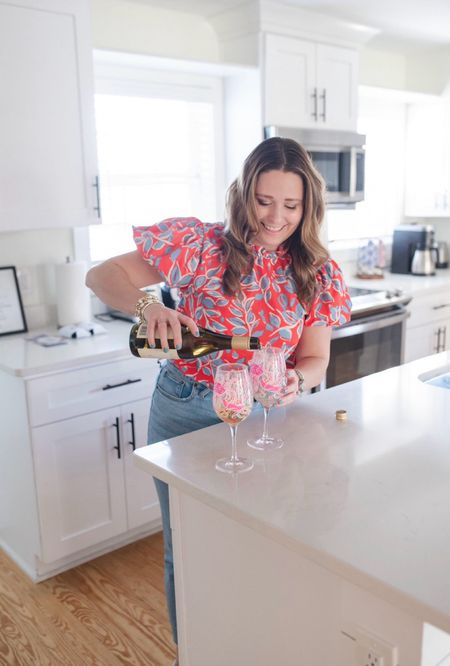 Red floral top with the best light wash jeans and Lilly Pulitzer wine glasses 