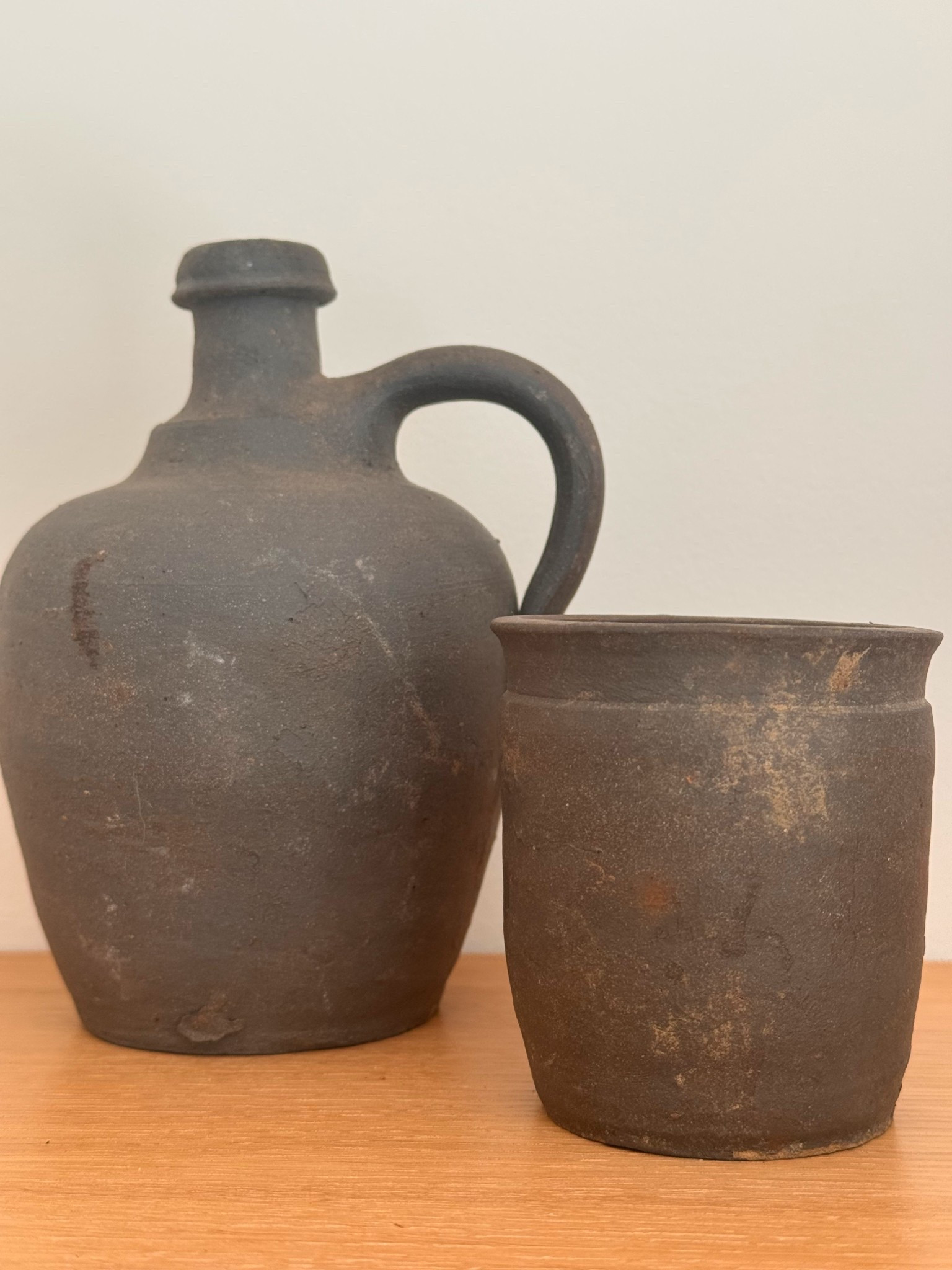 Two pieces of rustic French pottery that instantly make a shelf feel collected.

The tall cruche is a beautiful antique earthenware vessel believed to originate from the Gers region of Gascony in southwest France — an area known for its simple, utilitarian farmhouse pottery. Its dark charcoal clay body and sculptural handle make it a striking piece for shelf styling or kitchen counters.

Paired beside it is a small primitive pantry pot with the same rich charcoal patina. Pieces like this were traditionally used for storing salt, confit, or small pantry staples in French country kitchens.

I love layering vessels like these together — the difference in height and form creates that effortless, timeworn European feel.

Both pieces are available now in my Etsy shop.

Objects with a past — curated and collected in France.


#LTKHome