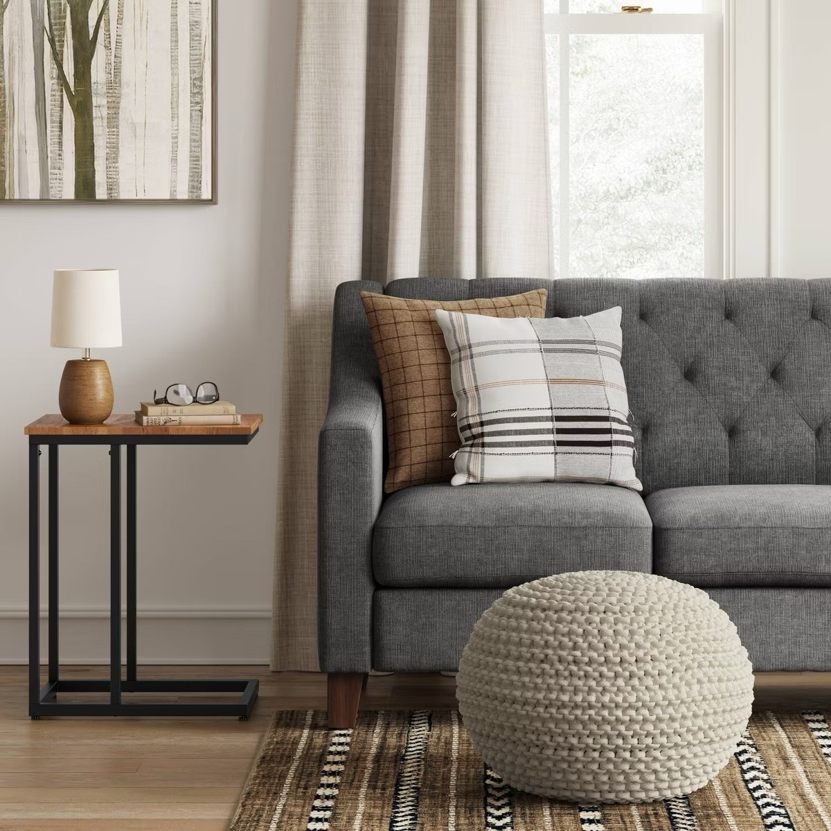 Cozy corner goals 🤎
Loving this mix of warm neutrals and textures — the tufted gray sofa, plaid throw pillows, knit pouf, and modern wood side table make the perfect combo for a soft, inviting living space. Neutral tones never go out of style ✨

#TargetHome #LivingRoomDecor #CozyHomeVibes #NeutralDecor #HomeInspo #LTKHome #TargetFinds #ModernLivingRoom #SofaGoals #HomeStyling #WarmNeutrals