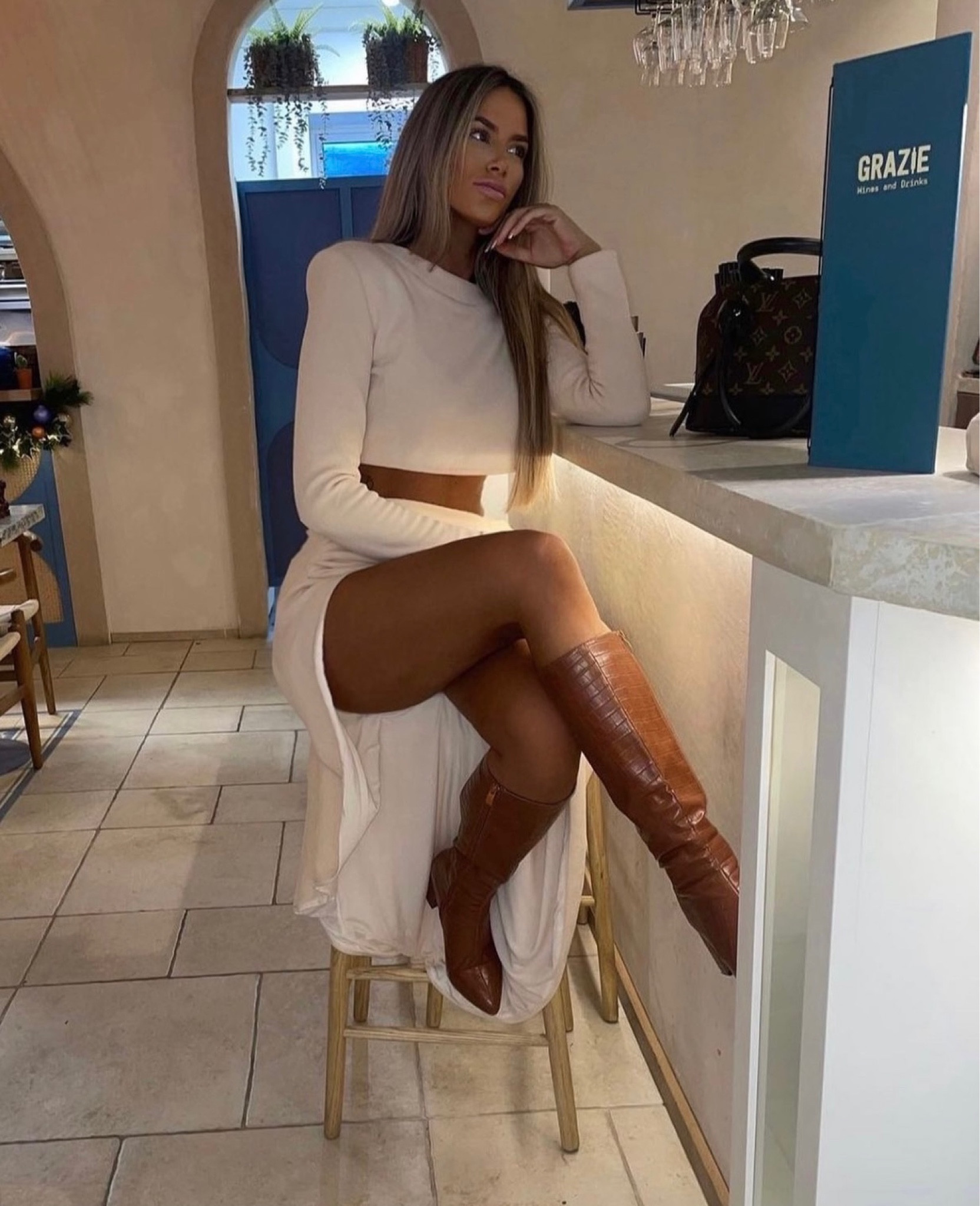 Cream skirt coord, skirt has a split and the jumper is cropped. Paired with brown/tan boots. 

#LTKfindsunder50 #LTKfindsunder100 #LTKSeasonal