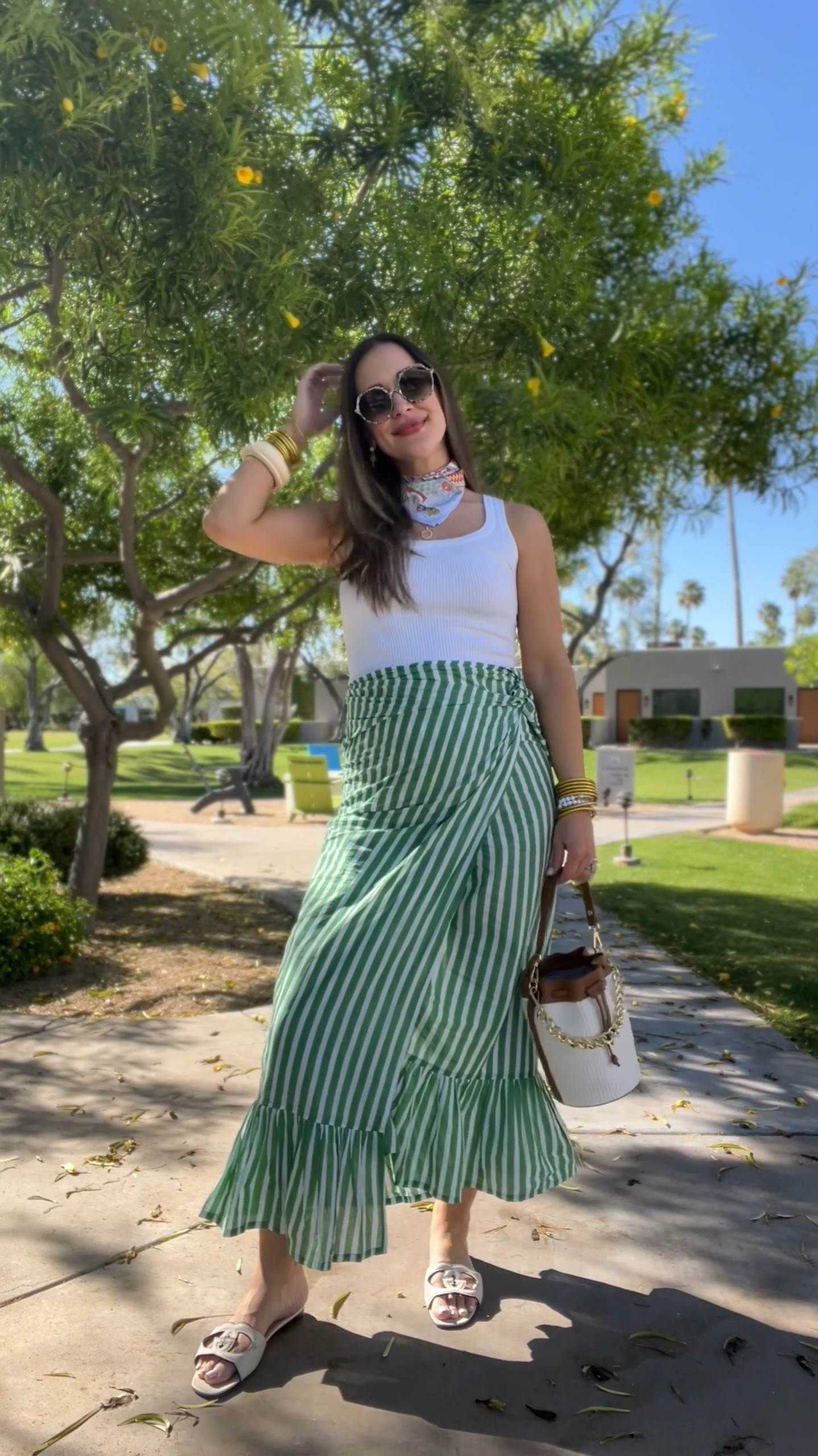 Green striped cotton sarong, Amazon tank, Hermes scarf, lots of bangles and raffia bucket bag