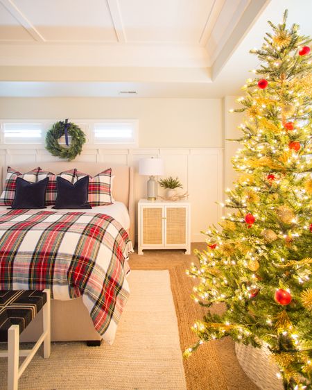We love the glow of the Christmas tree at night in our master bedroom decorated for Christmas! Items include plaid bedding and shams, blue velvet pillows, faux wreath with blue ribbon, king sized upholstered wingback bed, blue and natural wicker bench, white nightstand with cane inset doors and a simple white and tan jute area rug. Items not shown include a large wood beaded chandelier and striped linen curtains. 

Christmas décor, Christmas tree, neutral Christmas decor, Christmas bedroom, stewart plaid, Christmas pillows, bedroom bench, target bed, pottery barn bedding, faux Christmas tree, rug on carpet, bedroom area rug, tree collar, #ltkholiday #ltkfamily  

#LTKSeasonal #LTKstyletip #LTKunder50 #LTKunder100 #LTKhome #LTKsalealert #LTKHoliday #LTKhome #LTKSeasonal