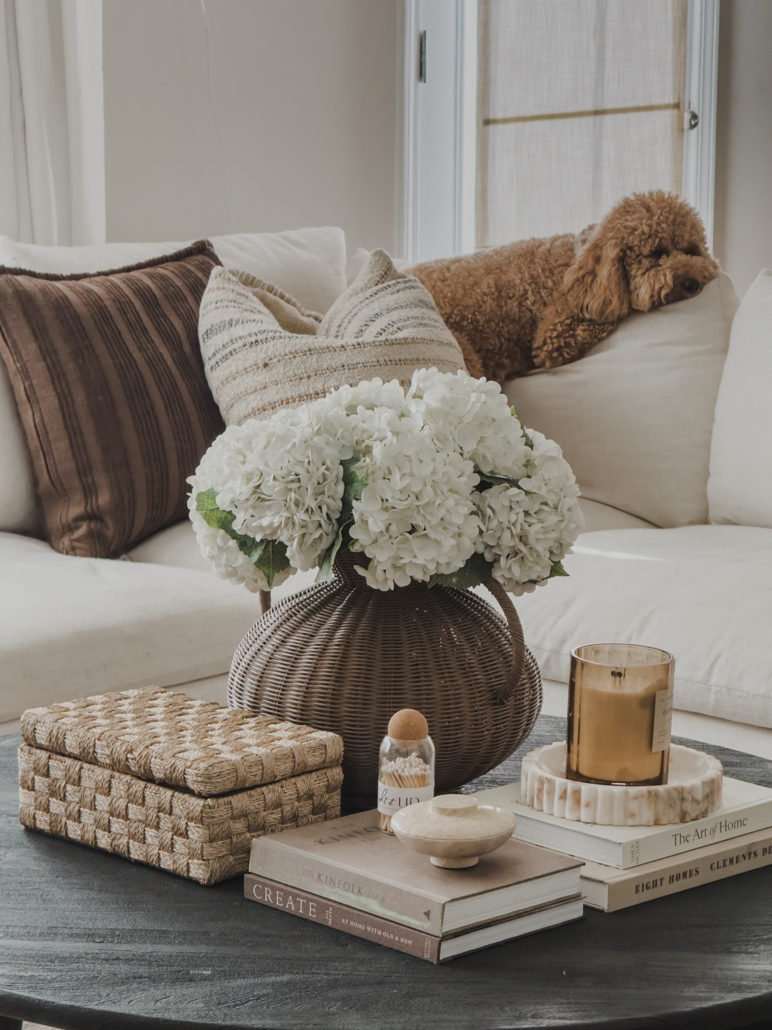 Living room close up shot. Sharing the way I styled my coffee table with both aesthetic and function. The wicker decor box adds texture but also stores remotes and all of the extras. 

Also, sharing my favorite textured throw pillows. The quality is amazing!
