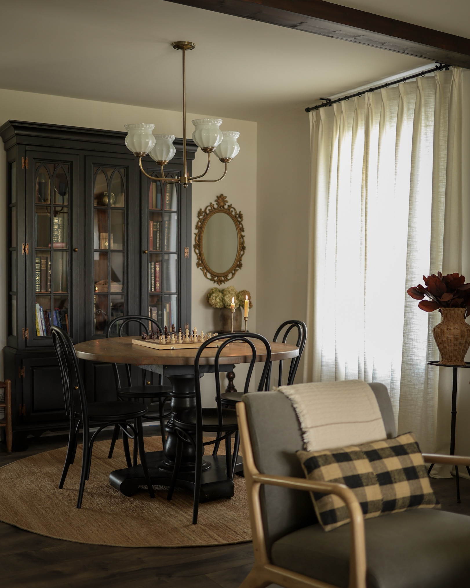 Round dining table, milk glass chandelier, round Jute rug, black chairs, pinch pleat curtains 

#LTKHome #LTKFindsUnder100 #LTKSaleAlert