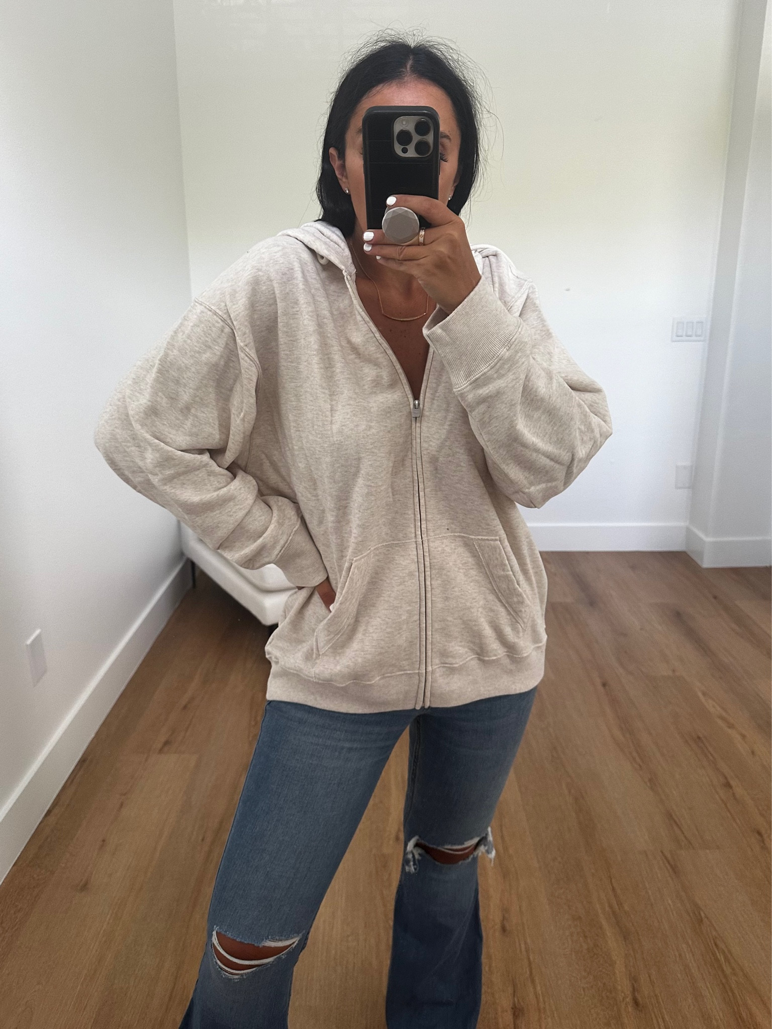 High-Rise Ripped Medium Wash Flare Jeans wearing size six. Oversized Zip-Up Hoodie wearing size medium