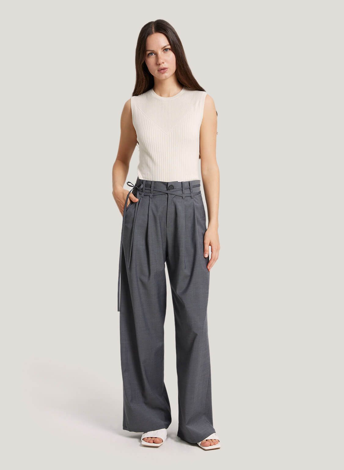 These pants are made from a wool blend fabric. The pants feature a high-rise, a tie detail at the... | Gentle Herd