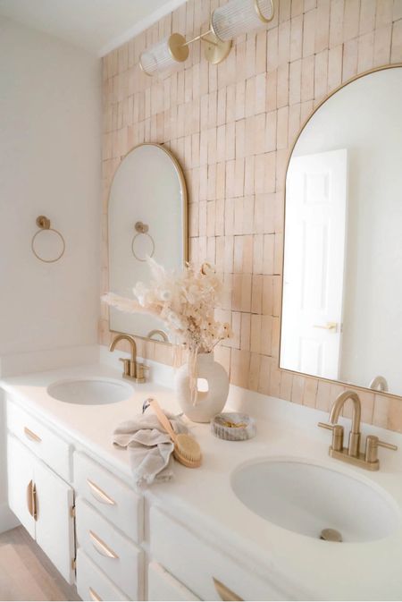 My dream bathroom 💗 sharing everything we used to create this space!

We used zelliege tile to create an accent wall and paired it with double brass arched mirrors + matching faucets and new vanity hardware.

#LTKstyletip #LTKfindsunder50 #LTKhome