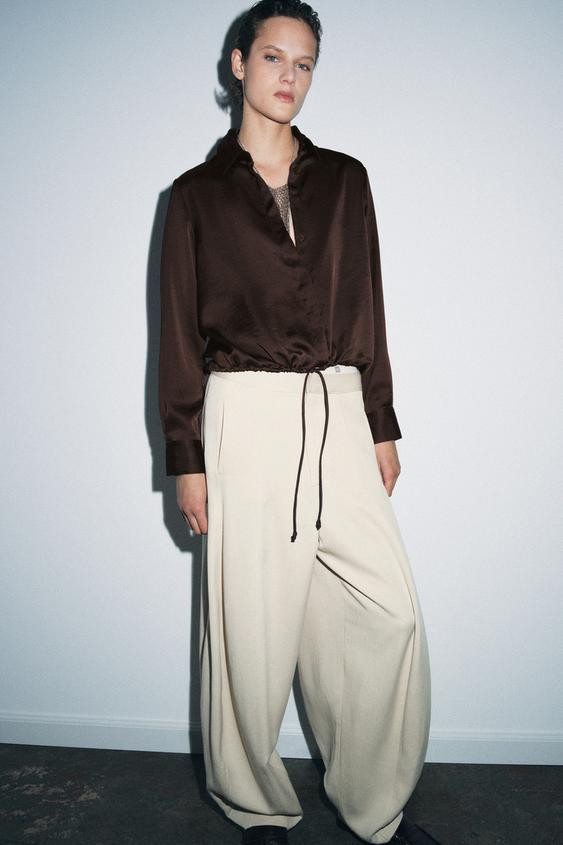 ZARA WOMAN COLLECTIONLapel collar satin effect shirt with long cuffed sleeves. Adjustable hem wit... | Zara US